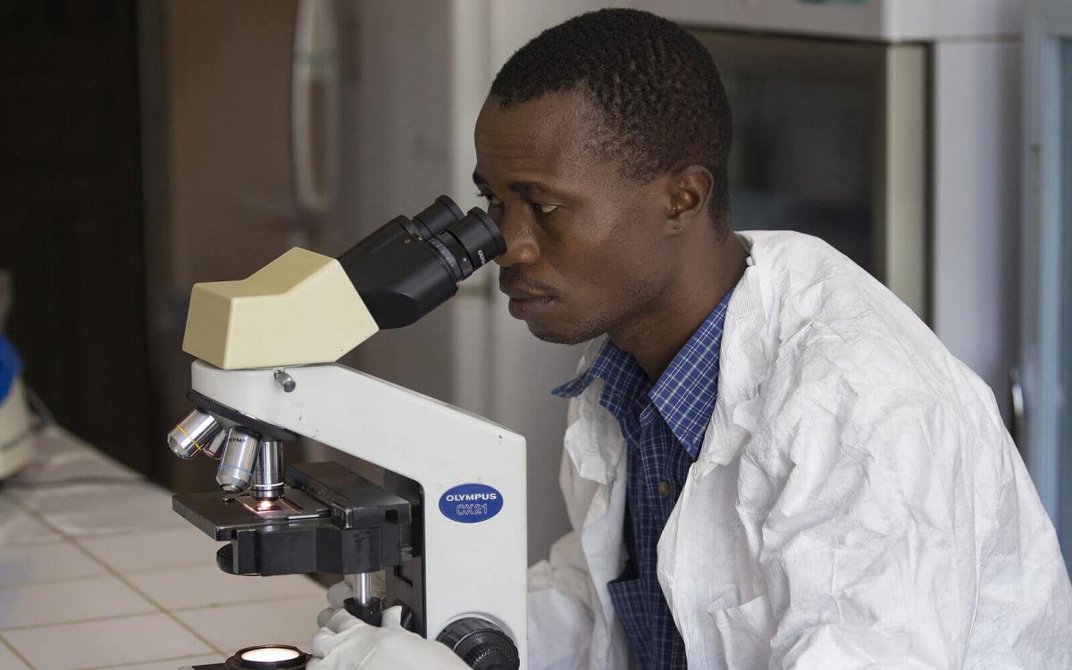 Man looking through microscope