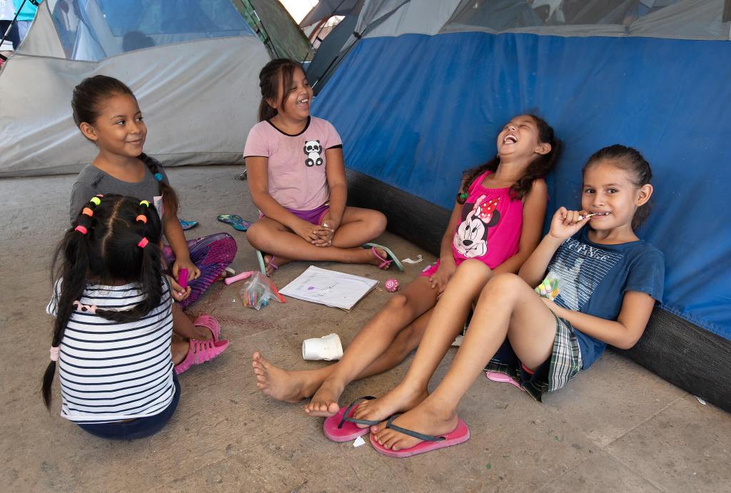 children playing in makeshift camp