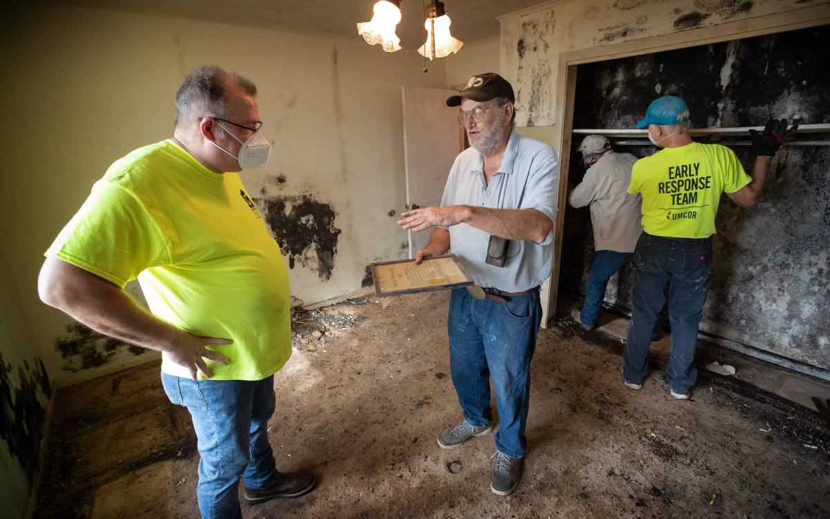 pastor visiting with LA resident after Ida