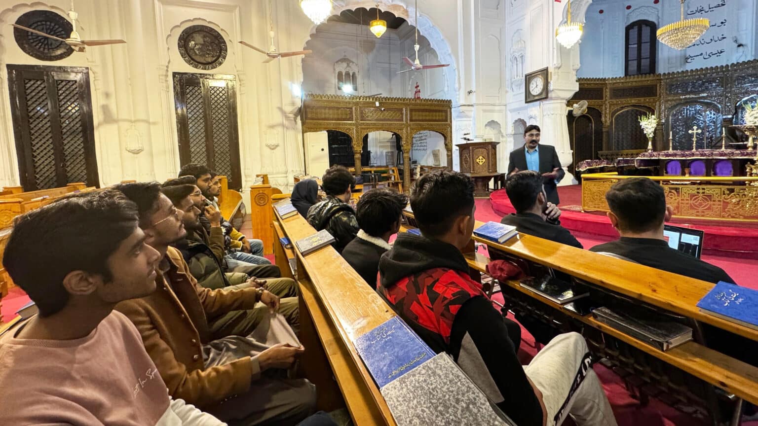 Insar Gohar (standing) leads a study session in his church. (Photo: Courtesy of Insar Gohar)
